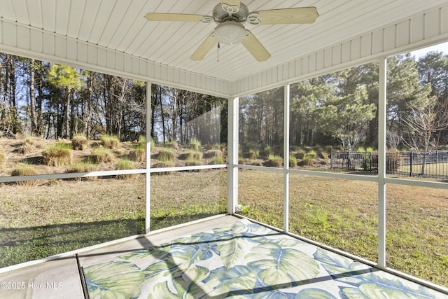 unfurnished sunroom with a wealth of natural light and ceiling fan