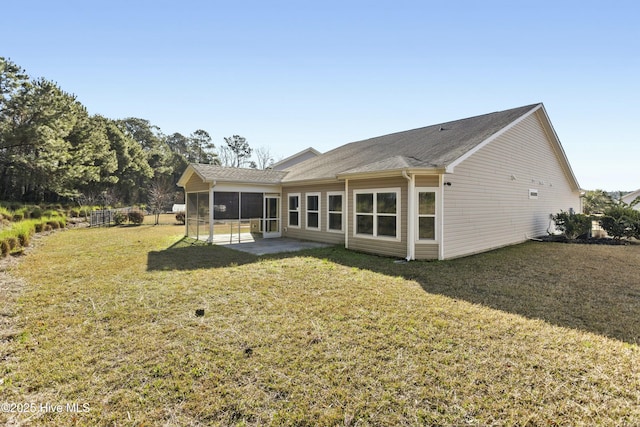 back of house with a patio area, a lawn, and a sunroom