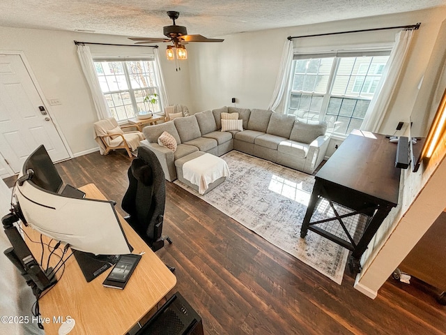 living room with plenty of natural light, wood finished floors, and a textured ceiling