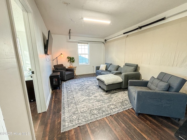 living room featuring dark wood-type flooring and baseboards