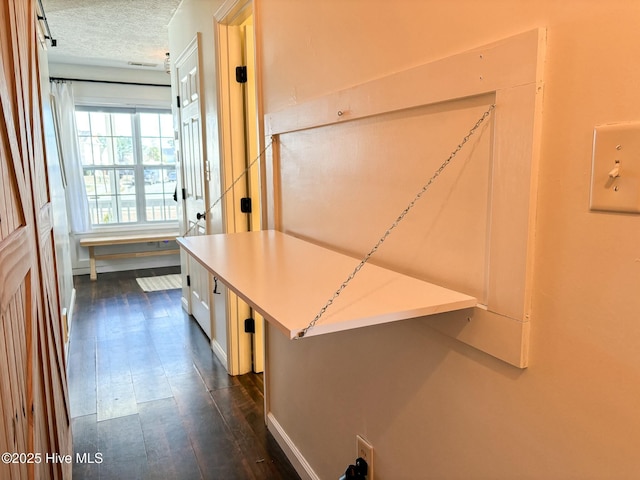 hallway featuring a textured ceiling