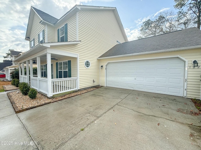 view of side of property with concrete driveway, roof with shingles, covered porch, an attached garage, and a ceiling fan
