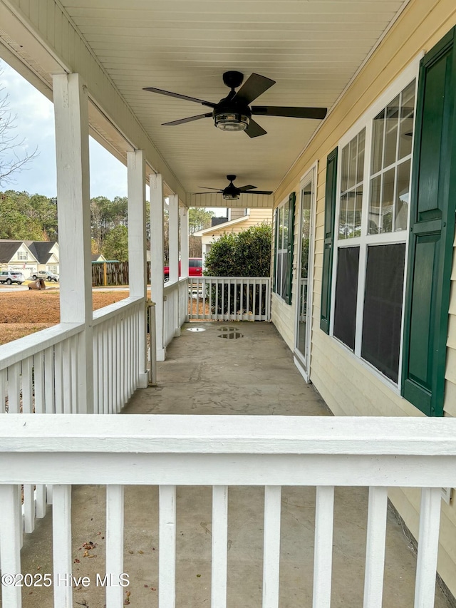 wooden deck with covered porch and a ceiling fan