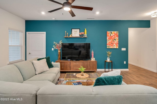 living area featuring visible vents, baseboards, recessed lighting, wood finished floors, and a ceiling fan