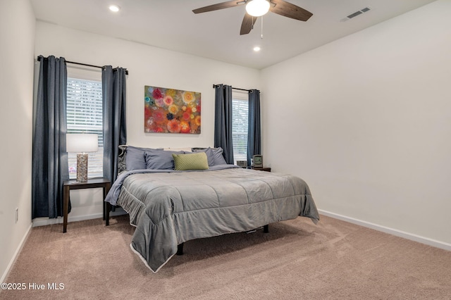 bedroom featuring light carpet, visible vents, and baseboards