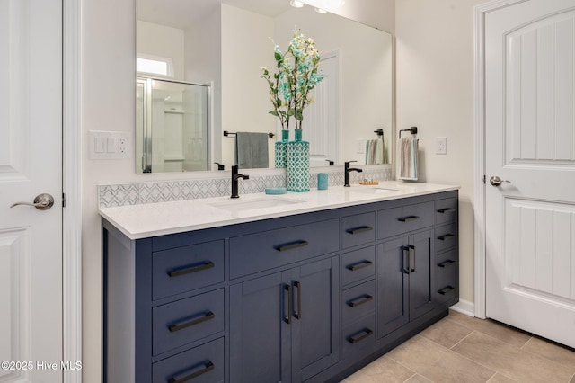 full bath featuring decorative backsplash, a shower stall, double vanity, and a sink