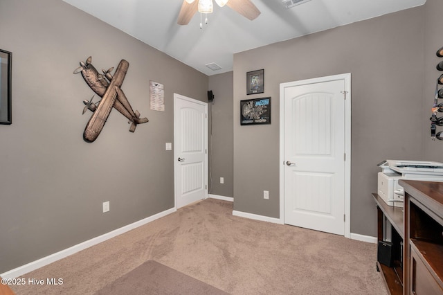 interior space featuring carpet flooring, visible vents, a ceiling fan, and baseboards