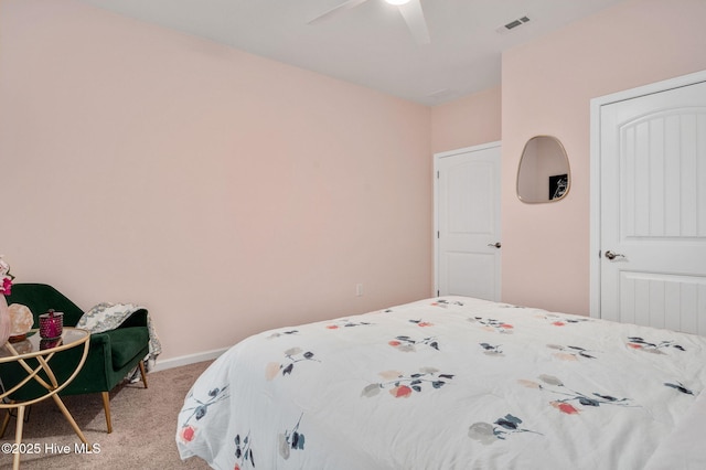 carpeted bedroom featuring baseboards, visible vents, and ceiling fan