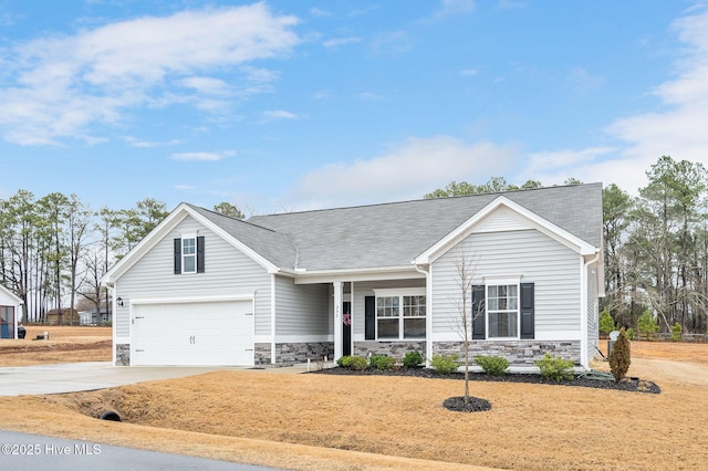 view of front facade featuring stone siding, driveway, a garage, and roof with shingles