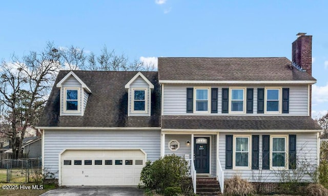 view of front of property with fence, driveway, an attached garage, a chimney, and a shingled roof