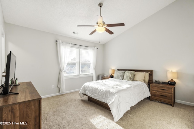 bedroom featuring visible vents, a textured ceiling, baseboards, lofted ceiling, and light colored carpet