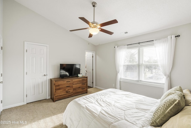 bedroom featuring vaulted ceiling, baseboards, visible vents, and light carpet