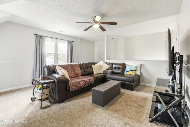 living area featuring a textured ceiling, carpet, baseboards, and ceiling fan