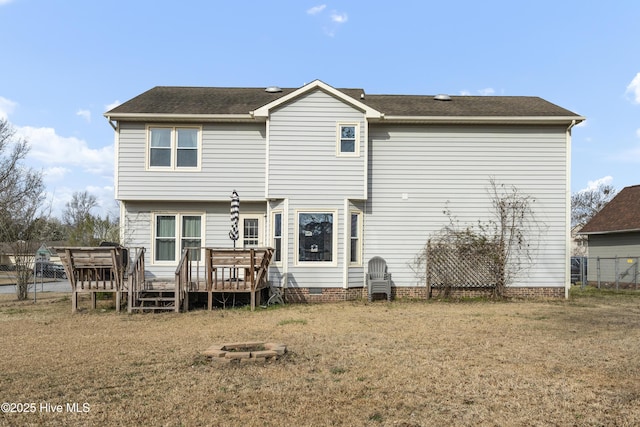 back of property featuring crawl space, a deck, and fence