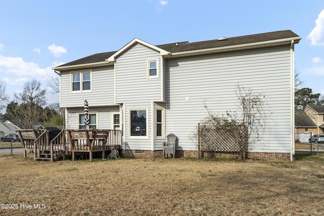 back of property with crawl space, a wooden deck, a yard, and fence