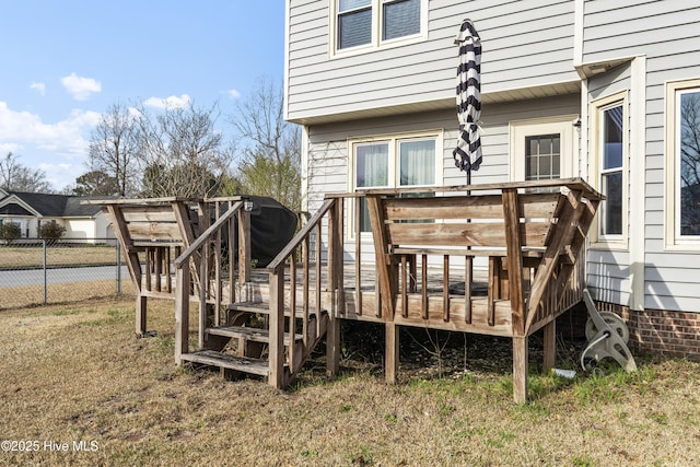 rear view of house with a deck and fence