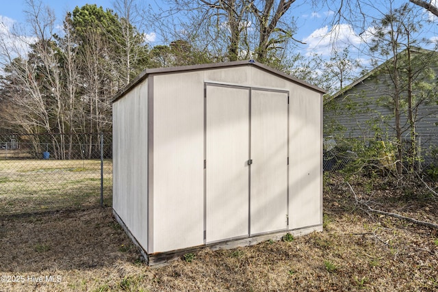 view of shed featuring fence