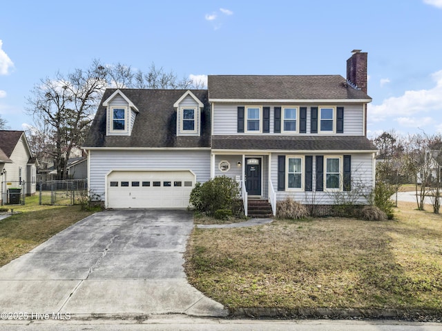 traditional home with a shingled roof, fence, concrete driveway, a front yard, and a chimney