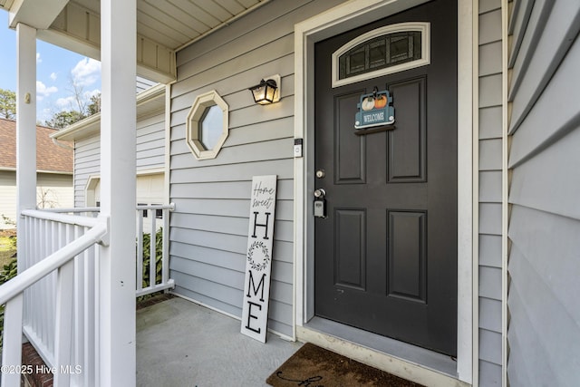 doorway to property featuring covered porch