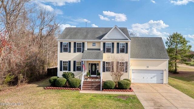 124 Matthews Dr, Elizabeth City, NC 27909 - view of front of house featuring a shingled roof, a front yard, an attached garage, and concrete driveway