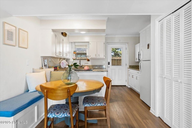 298 Ocean Blvd W # 103, Holden Beach, NC 28462 - dining space with crown molding, dark wood-type flooring, and breakfast area