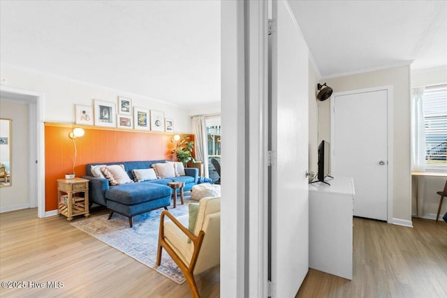 298 Ocean Blvd W # 103, Holden Beach, NC 28462 - living area featuring baseboards, ornamental molding, light wood-style flooring, and plenty of natural light
