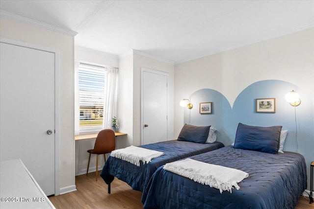 298 Ocean Blvd W # 103, Holden Beach, NC 28462 - bedroom with baseboards, ornamental molding, and wood finished floors