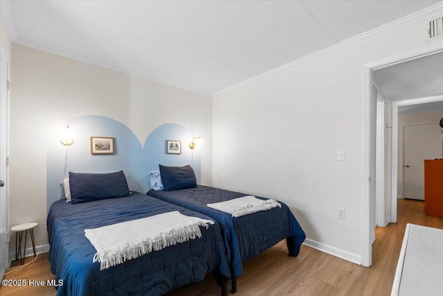 298 Ocean Blvd W # 103, Holden Beach, NC 28462 - bedroom featuring baseboards, wood finished floors, and visible vents