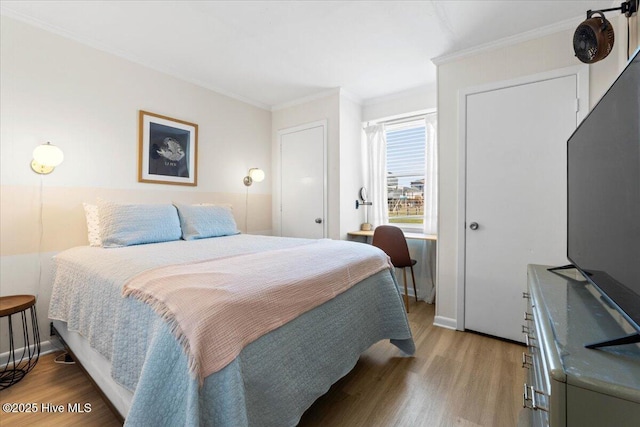 298 Ocean Blvd W # 103, Holden Beach, NC 28462 - bedroom with baseboards, ornamental molding, and wood finished floors