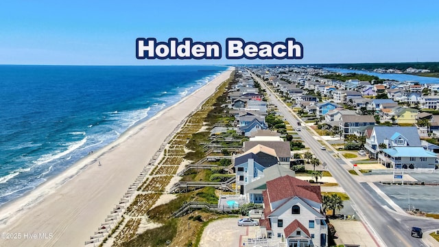 298 Ocean Blvd W # 103, Holden Beach, NC 28462 - drone / aerial view featuring a water view and a beach view