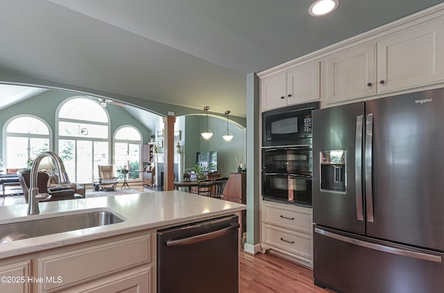 1335 Midland Rd, Southern Pines, NC 28387 - kitchen featuring black appliances, a sink, light wood-style flooring, open floor plan, and light stone counters