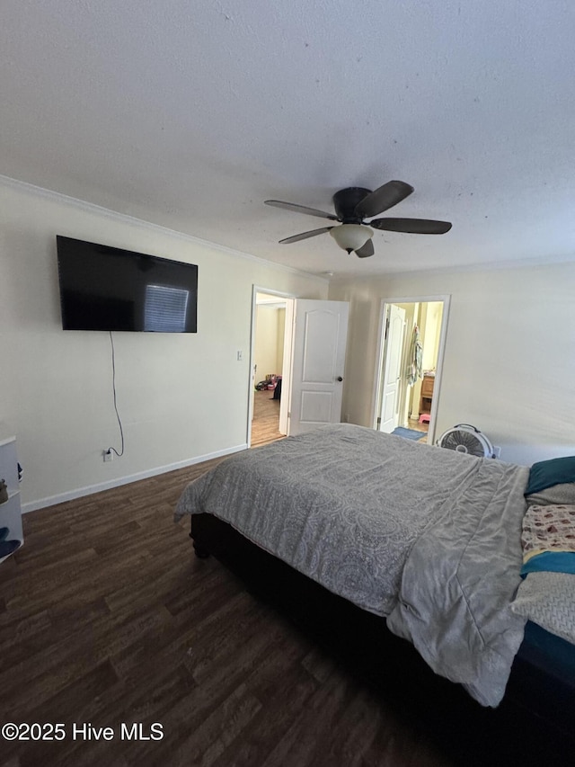 bedroom featuring ceiling fan, baseboards, ensuite bath, and wood finished floors