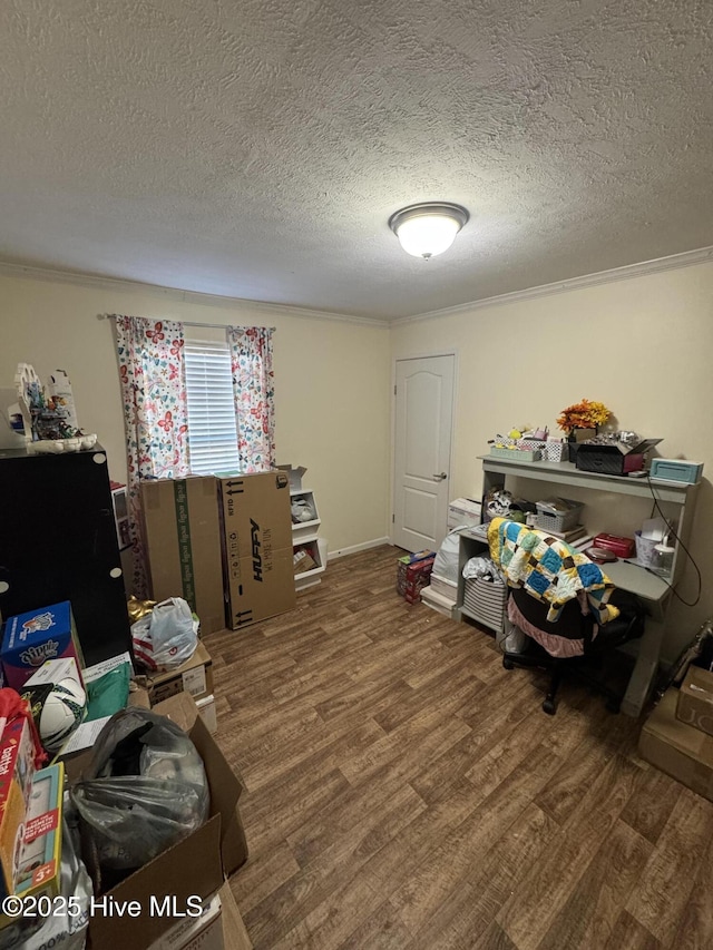 playroom featuring crown molding, wood finished floors, and a textured ceiling