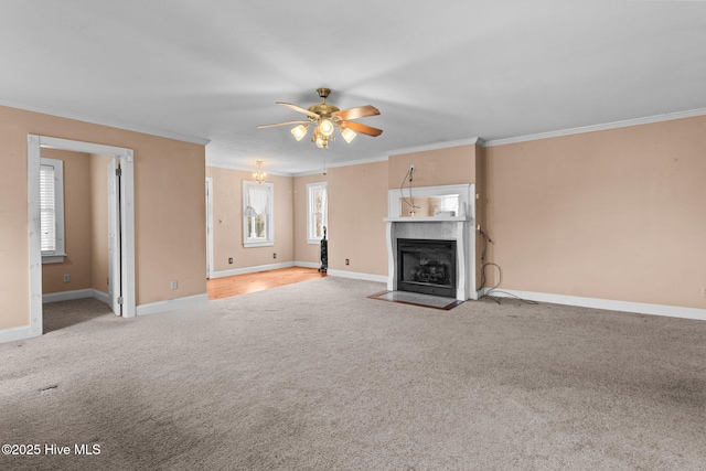 unfurnished living room with carpet floors, ceiling fan, and crown molding