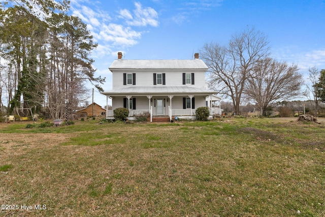 view of front of house featuring a front lawn, a porch, and a chimney