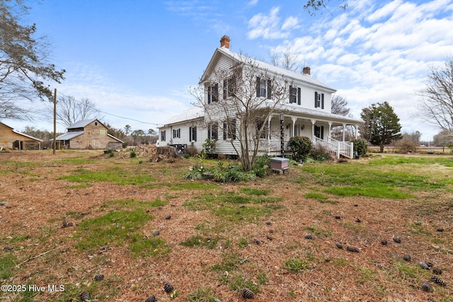 exterior space featuring covered porch and a chimney