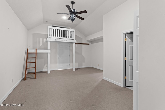 unfurnished bedroom featuring baseboards, lofted ceiling, and carpet floors