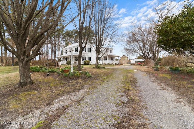 exterior space featuring a porch and driveway