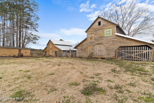 rear view of house featuring an outbuilding and a barn