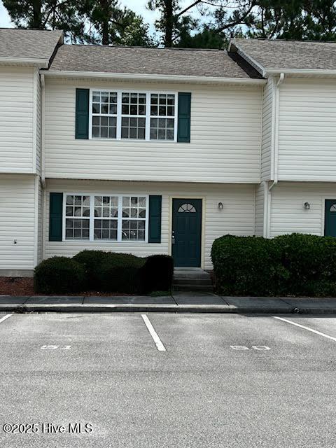 townhome / multi-family property with uncovered parking and entry steps