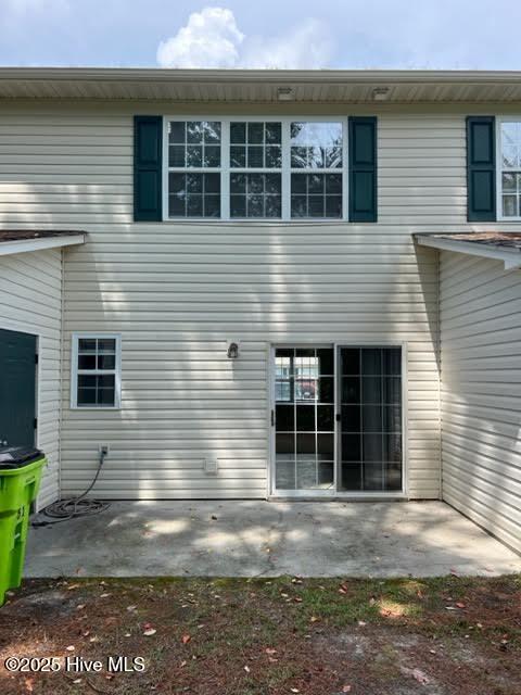 rear view of property featuring a patio area