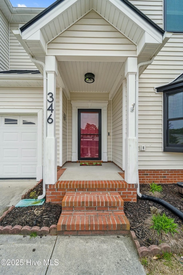 view of exterior entry with an attached garage