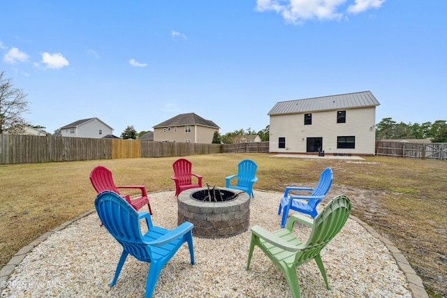 view of yard with a patio area, an outdoor fire pit, and a fenced backyard