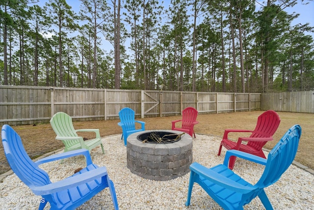 view of yard featuring a patio, a fire pit, and a fenced backyard