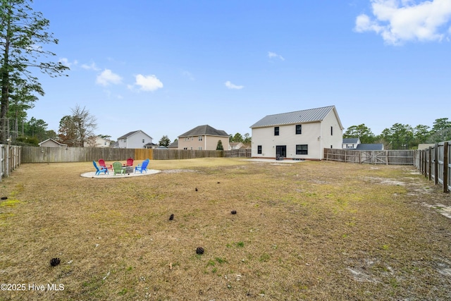 view of yard featuring a patio area, an outdoor fire pit, and a fenced backyard