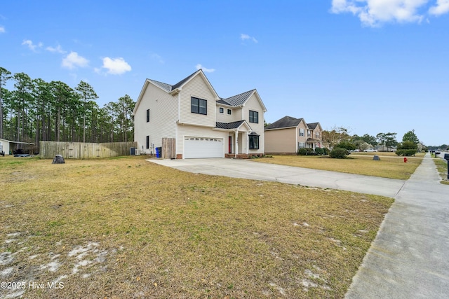 view of front of home with a garage, concrete driveway, a front lawn, and fence