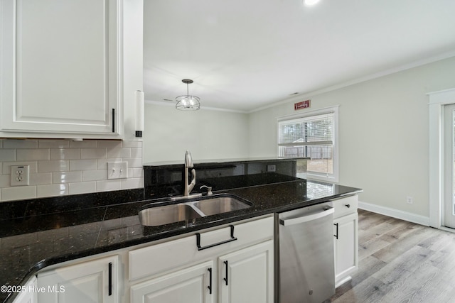 kitchen with dishwasher, crown molding, tasteful backsplash, and a sink