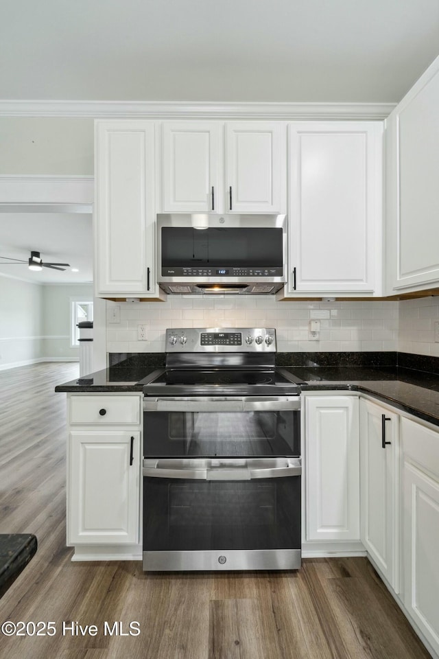 kitchen with white cabinetry, tasteful backsplash, and appliances with stainless steel finishes