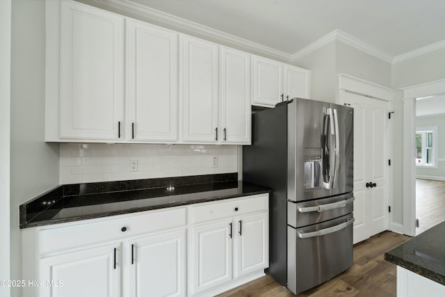 kitchen featuring decorative backsplash, dark wood-type flooring, white cabinets, stainless steel refrigerator with ice dispenser, and crown molding