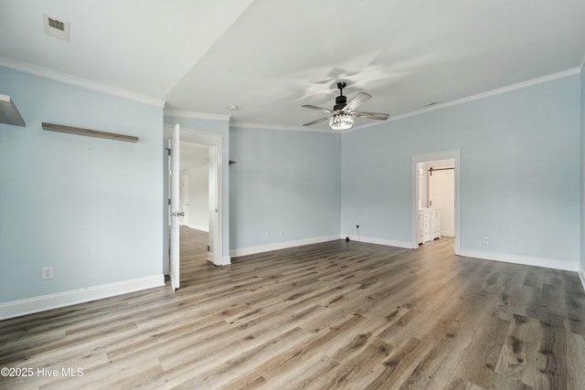 empty room with visible vents, baseboards, wood finished floors, and a ceiling fan